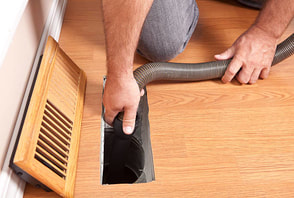 contractor cleaning a vent passage